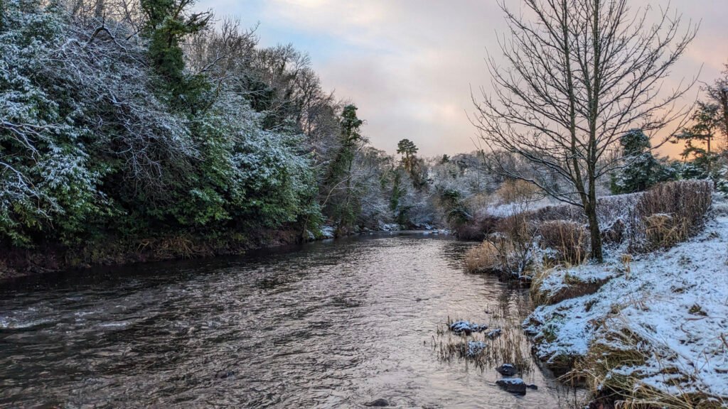 Lovers retreat river in the snow looking to the west