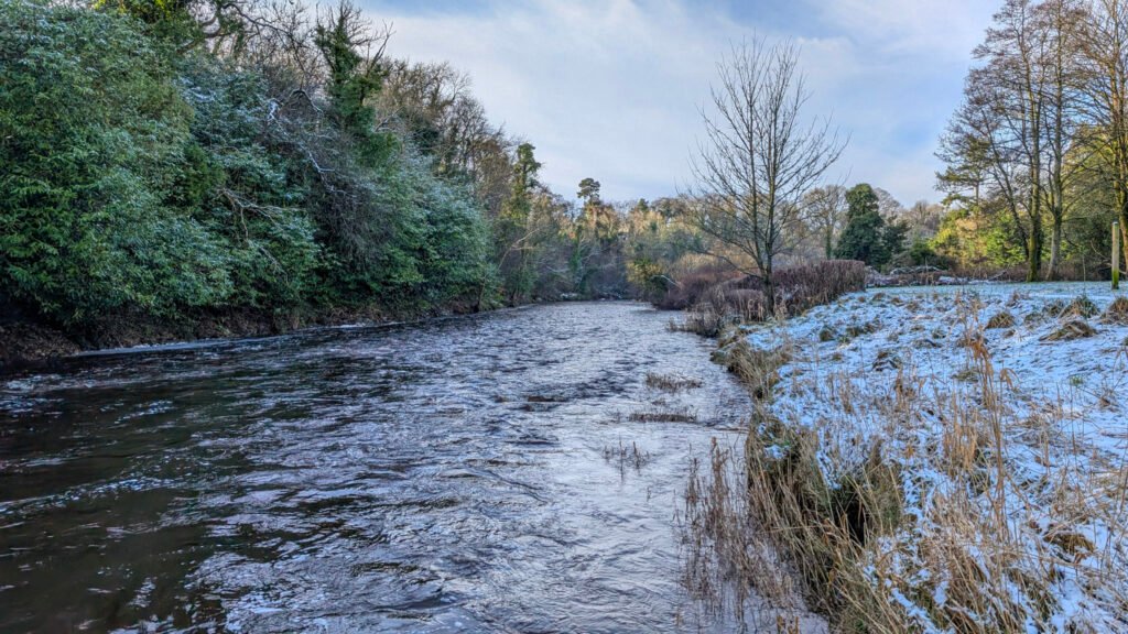 Mid river at Lover's Retreat looking west in the snow in Omagh